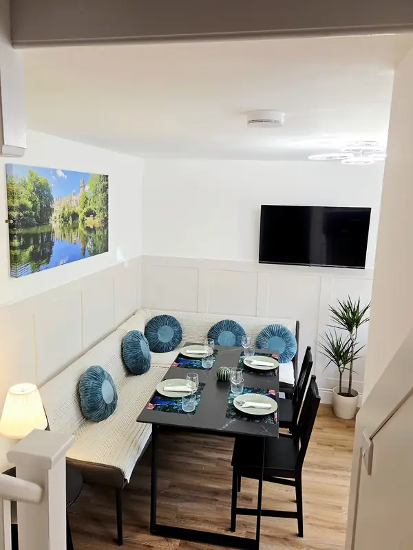 The corner banquette and dining table laid for four