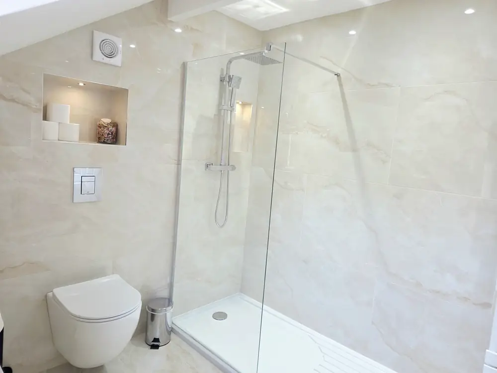 The walk-in rainfall shower and lit niche