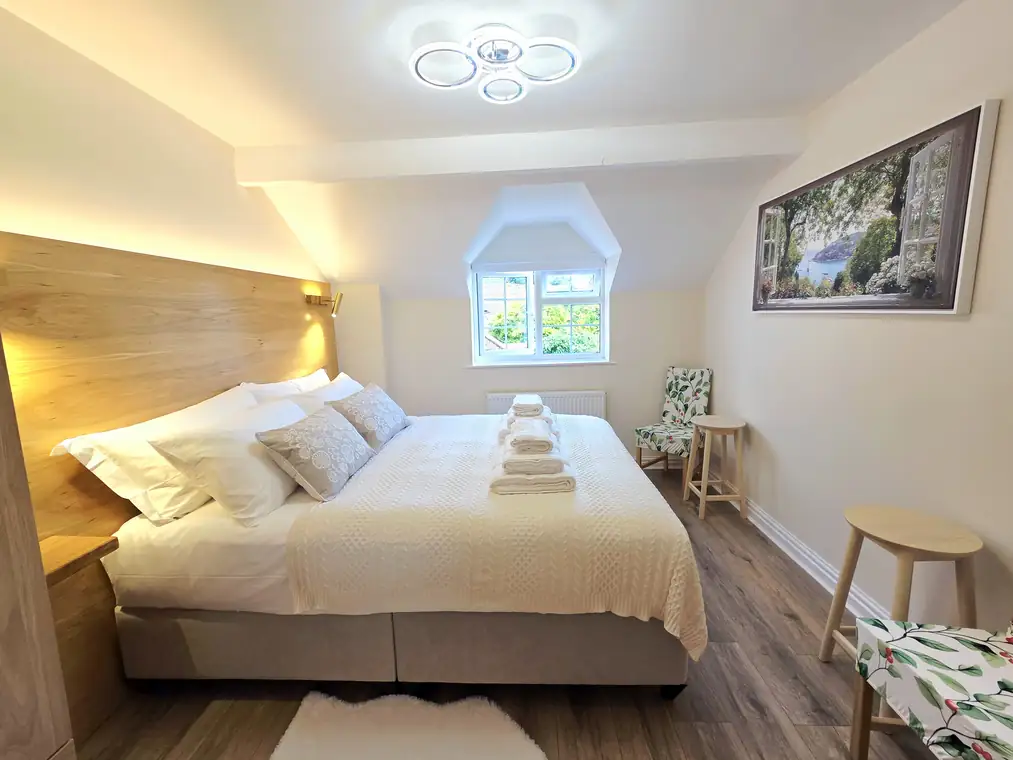Morning light entering the main bedroom through the dormer