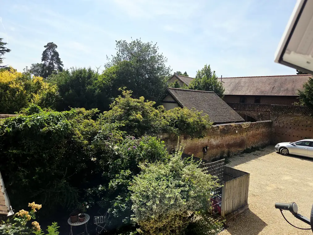 A view over the shared courtyard and parking from the main bedroom