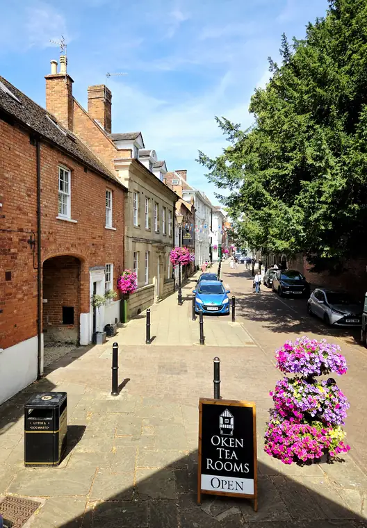 Castle Street, Warwick, with hanging baskets and the archway into Castle Mews