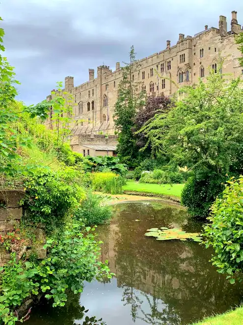 Warwick Castle seen from Mill Garden, above the water