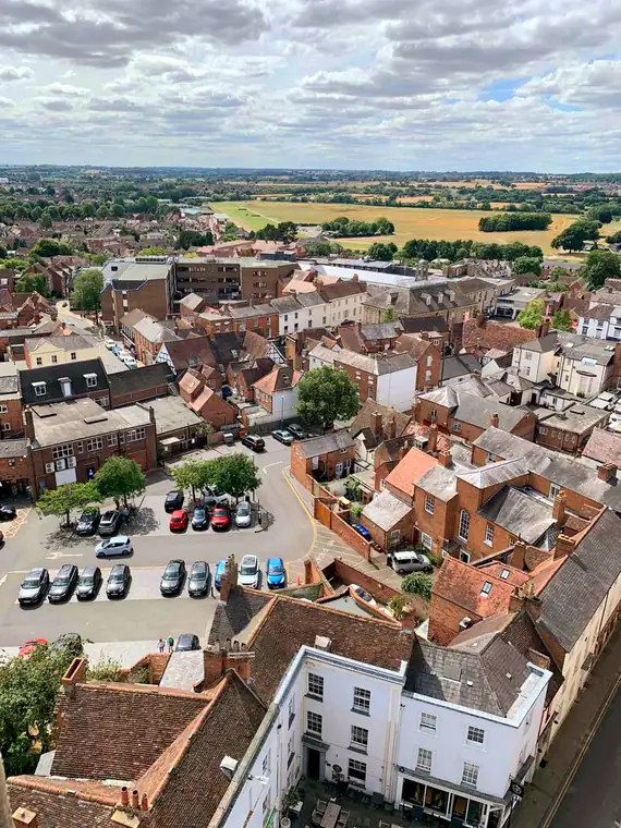 Warwick rooftops seen from St Mary's church tower, with the racecourse and open country beyond