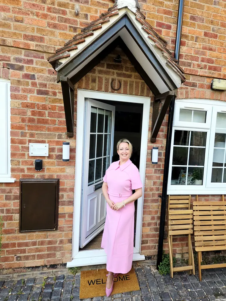 Viktoriia at the door of Victoria's Place